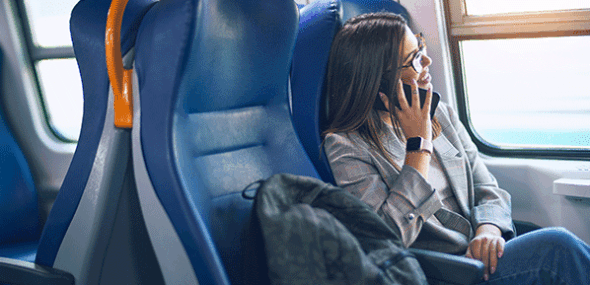 Passengers making phone calls relaxed during a train ride in a modern regional train