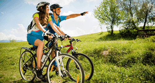Cyclists with helmets taking a break during a bicycle tour in nature